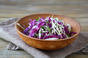 Organic cabbage in a wooden bowl, food closeup